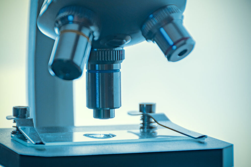 process of medical research invitro under a microscope concept